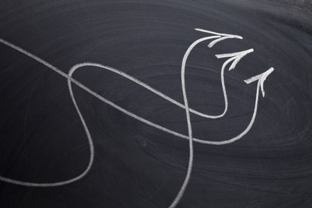 coming together or convergence concept - white chalk drawing on a blackboardの写真素材