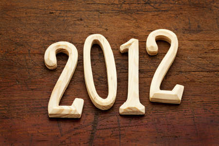 2012 year in unfinished wood letters  against old grunge wooden background
