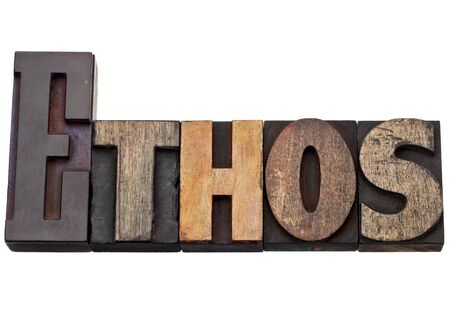 ethos - culture concept - isolated text in vintage wood letterpress printing blocks, stained by color inksの写真素材