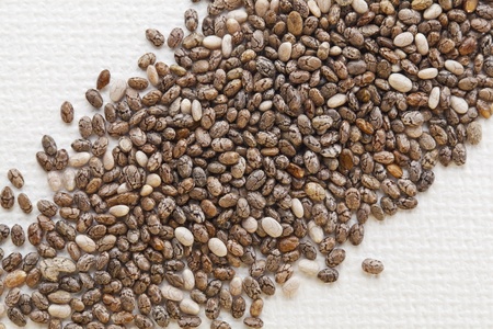 organic chia seeds rich in omega-3 fatty acids, diagonal composition on white artist canvas
