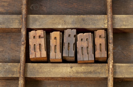 ligature - vintage wooden letterpress printing blocks in an old grunge typesetter drawerの写真素材