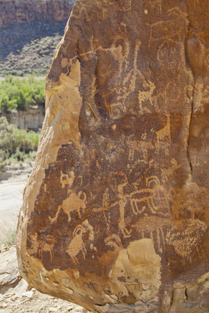 petroglyph panel from the NIne Mile Canyon in northeastern Utah with high concentration of rock art from Fremont Culture and ancient Ute, hunting scene with deer and bisonのeditorial素材