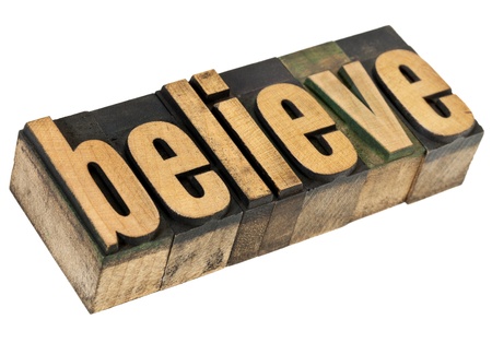 believe - spiritual concept - isolated text in vintage letterpress wood typeの写真素材