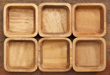 background and pattern of six wooden bowls with different wood grainの写真素材