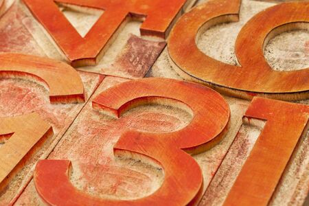 number abstract in vintage letterpress wood type stained by red and orange inksの写真素材