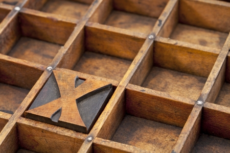 letter X abstract - vintage letterpress printing block in grunge wood typesetter box with dividersの写真素材