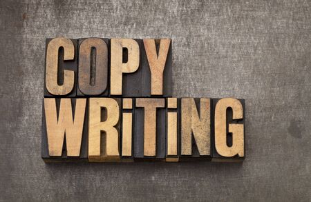 copywriting word - vintage letterpress wood type on a grunge metal backgroundの写真素材