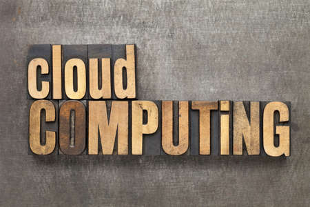 cloud computing - text in vintage letterpress wood type against a grunge metal sheetの写真素材