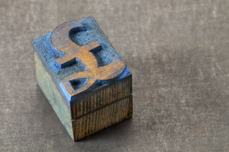 pound currency symbol - vintage letterpress wood type block stained by blue ink on grunge metal backgroundの写真素材