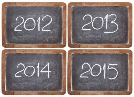 current and incoming years, 2012, 2013, 2014, 2015 on vintage slate  blackboards, isolated on whiteの写真素材