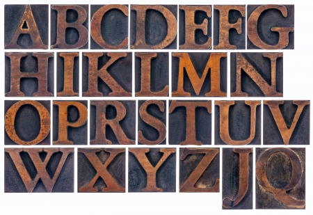 complete English alphabet  in vintage  wood type - a  collage of 26 isolated letterpress printing blocks stained by inkの写真素材
