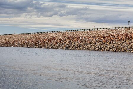 rock dam with highway - Horsetooth Reservoir near Fort Collins, Coloradoの写真素材