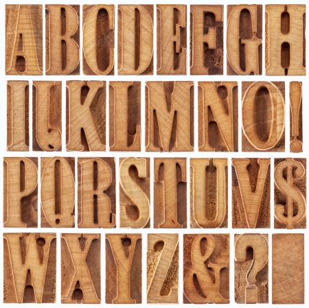 alphabet in modern letterpress wood type printing blocks (unused), a collage of 26 isolated letters, question mark, exclamation point, ampersand and dollar signの写真素材