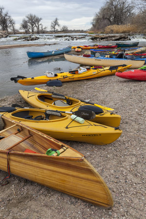 SOUTH PLATTE RIVER, EVANS, COLORADO - APRIL 6: Kayaks and canoes on a river shore below diversion dam during Annual All Club Paddle on April 6, 2013, a popular season opening paddling trip in northern Colorado.のeditorial素材