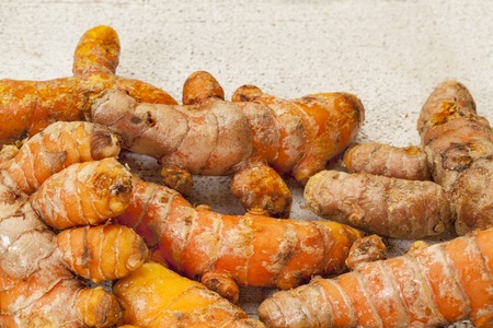 turmeric root on a rustic white painted rough barn wood surfaceの写真素材