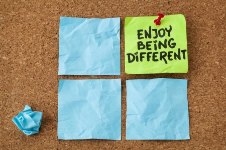 enjoy being different advice - lifestyle or nonconformist concept - handwriting on colorful sticky notesの写真素材
