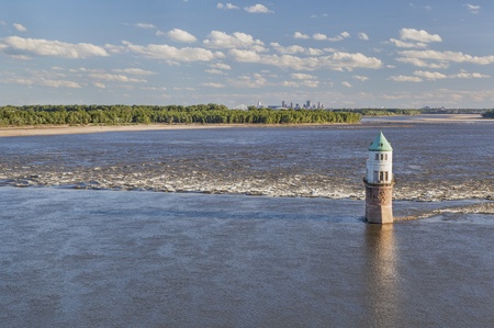 Mississippi RIver at Chain of Rocks with historical water intake tower and distant cityscape of St...