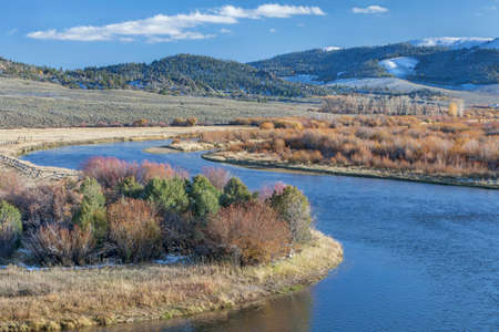 meanders of North Platte River above North Gate Canyon near Cowdrey, Colorado, in a fall scenery with some snow in surrounding mountainsの写真素材