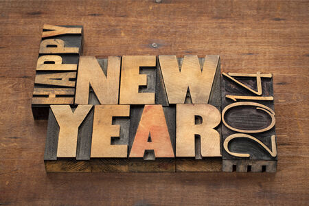 Happy New Year 2014 greetings or wishes - text in vintage letterpress wood type blocks on a grunge...