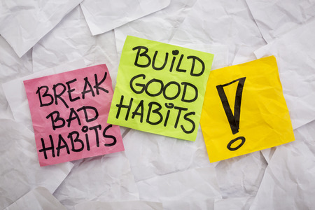 break bad habits, build good habits - motivational reminder on colorful sticky notes - self-development conceptの写真素材