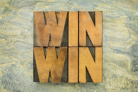 win-win - negotiation or conflict resolution strategy  -  words in letterpress wood type against slate rock backgroundの写真素材