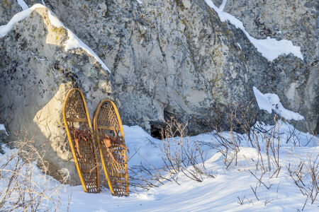 winter landscape with  sandstone rocks and classic Bear Paw snowshoesの写真素材