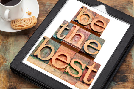 be the best - text in letterpress woodtype on a digital tablet with a cup of coffee - motivation...