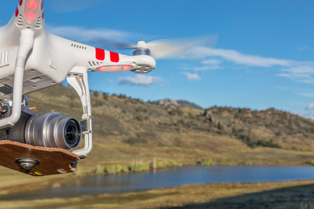 FORT COLLINS, CO, USA, September 30 2014:  Airborne radio controlled DJI Phantom quadcopter drone with Panasonic Lumix GM1 camera (home made mount) is flying over Pineridge Natural Area at Colorado foothills.のeditorial素材