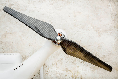 arm of a small quadcopter drone with a carbon fiber propellerの写真素材