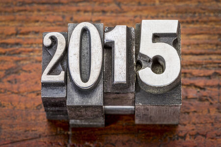 2015  - New Year concept  - text in vintage metal type over gungre woodの写真素材