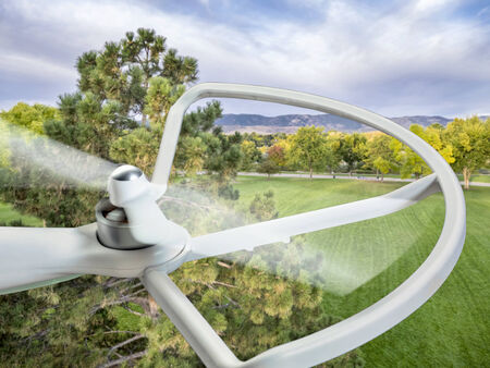 a spinning rotor of a small drone helicopter flying over parkの写真素材