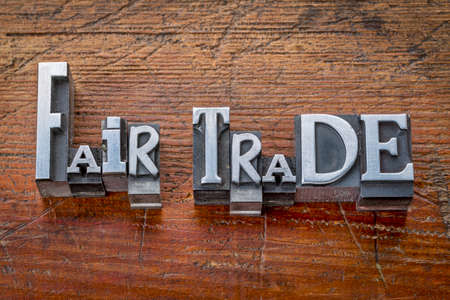fair trade words in vintage metal type printing blocks over grunge wood - ethical business conceptの写真素材
