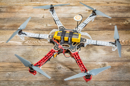 FORT COLLINS, CO, USA, November 18,  2014:  Radio controlled DJI  F550 Flame Wheel  hexacopter drone with NAZA V2 system on a wooden deck. This drone assembled from  a kit is ready to fly.のeditorial素材