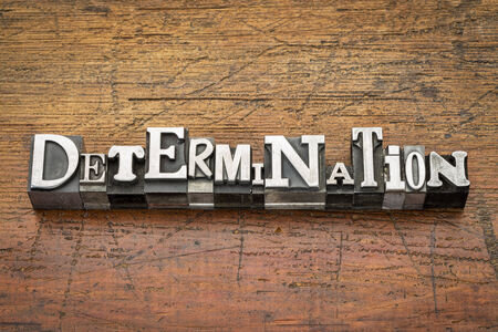 determination  word in mixed vintage metal type printing blocks over grunge wood