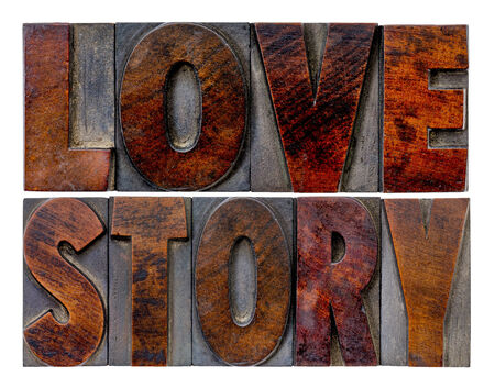 love story word abstract in vintage letterpress wood type blocks with ink patinaの写真素材