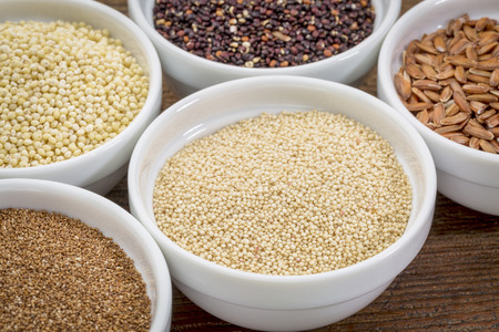 amaranth  and other gluten free grains (teff, millet, quinoa, brown rice)  in small ceramic bowlsの写真素材