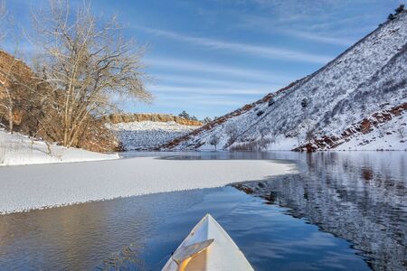 winter canoe paddling on Horsetooth Reservoir near Fort Collins in northern Coloradoの写真素材