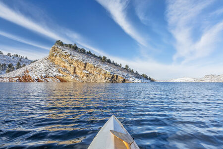 canoe paddling on Horsetooth Reservoir near Fort Collins in northern Colorado, winter sceneryの写真素材