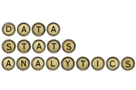 data, stats and analytics words in old round typewriter keys isolated on whiteの写真素材