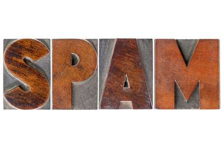 spam  word (unsolicited and unwanted commercial email messages) in isolated vintage wooden letterpress type blocksの写真素材