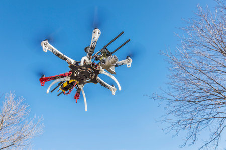 FORT COLLINS, CO, USA, December 2,  2014:  DJI  F550 Flame Wheel  hexacopter drone, assembled from a kit, flying with a prosumer camera.のeditorial素材