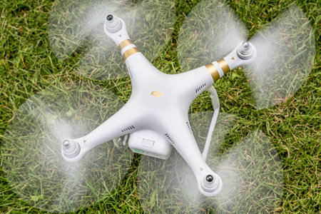 FORT COLLINS, CO, USA - AUGUST 28, 2015:  Radio controlled DJI Phantom 3 hexacopter drone is taking off from a backyard lawn.のeditorial素材