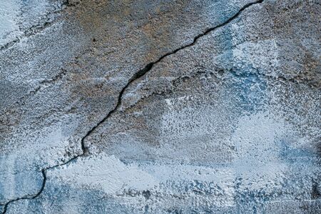 closeup of aging, grunge concrete wall texture with blue paint, cracks and chipsの写真素材