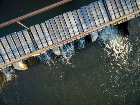 aerial view of river a diversion dam with a footbridge - Cache la Poudre RIver in northern Coloradoの写真素材