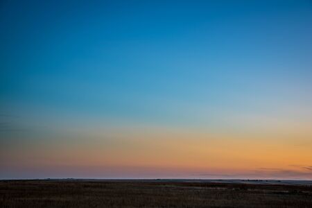 typical clear sky after sunset over Colorado prairie with dusk colorsの写真素材