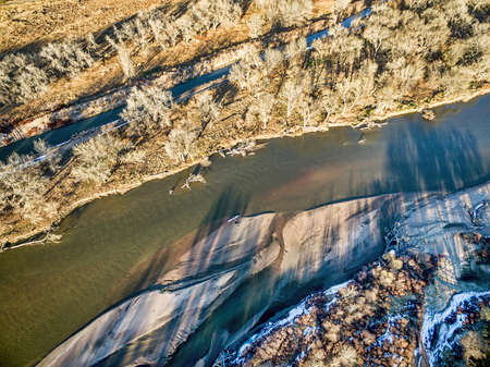 aerial view of South Platte River in eastern Colorado with a canoe on sandbar, fall sceneryの写真素材