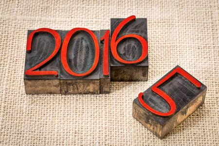 new year 2016 replacing the old year 2015 - letterpress wood type stained by red ink on a burlap canvasの写真素材