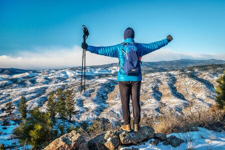 male hiker enjoying a view of Rocky Mountains foothills  - winter scenery at Horsetooth Mountain...