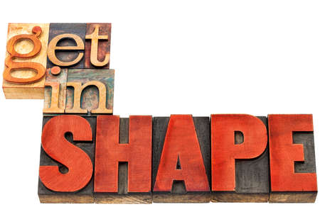 get in shape motivation banner  - fitness concept - isolated text  in vintage letterpress wood type stained by red inkの写真素材