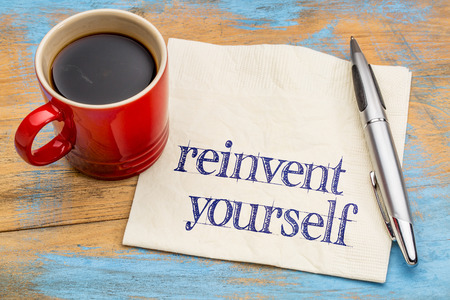 reinvent yourself  - motivational advice or self development concept - handwriting on a napkin with a cup of coffeeの写真素材